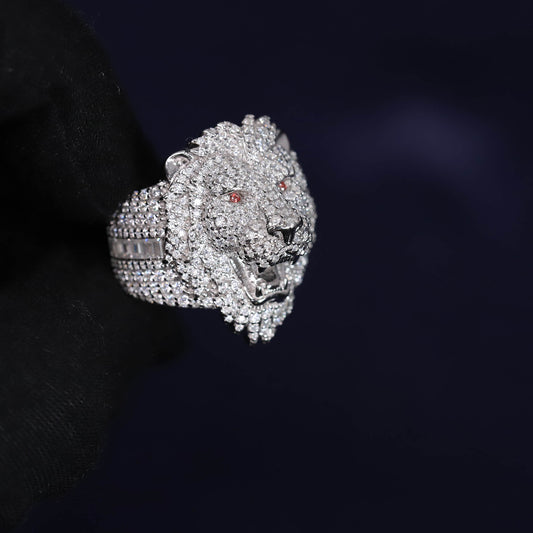 Luxury silver lion head ring with gemstones on a dark background