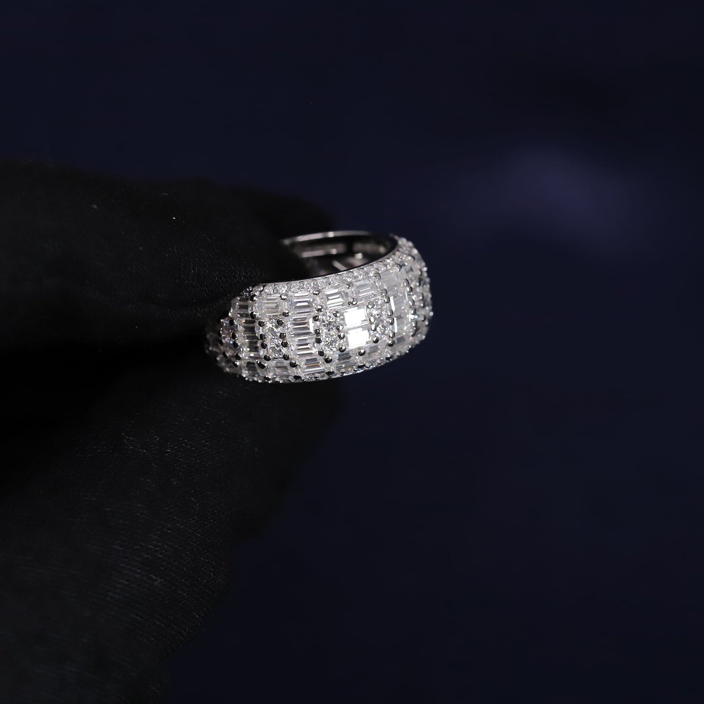 Silver ring with gemstones on a dark background