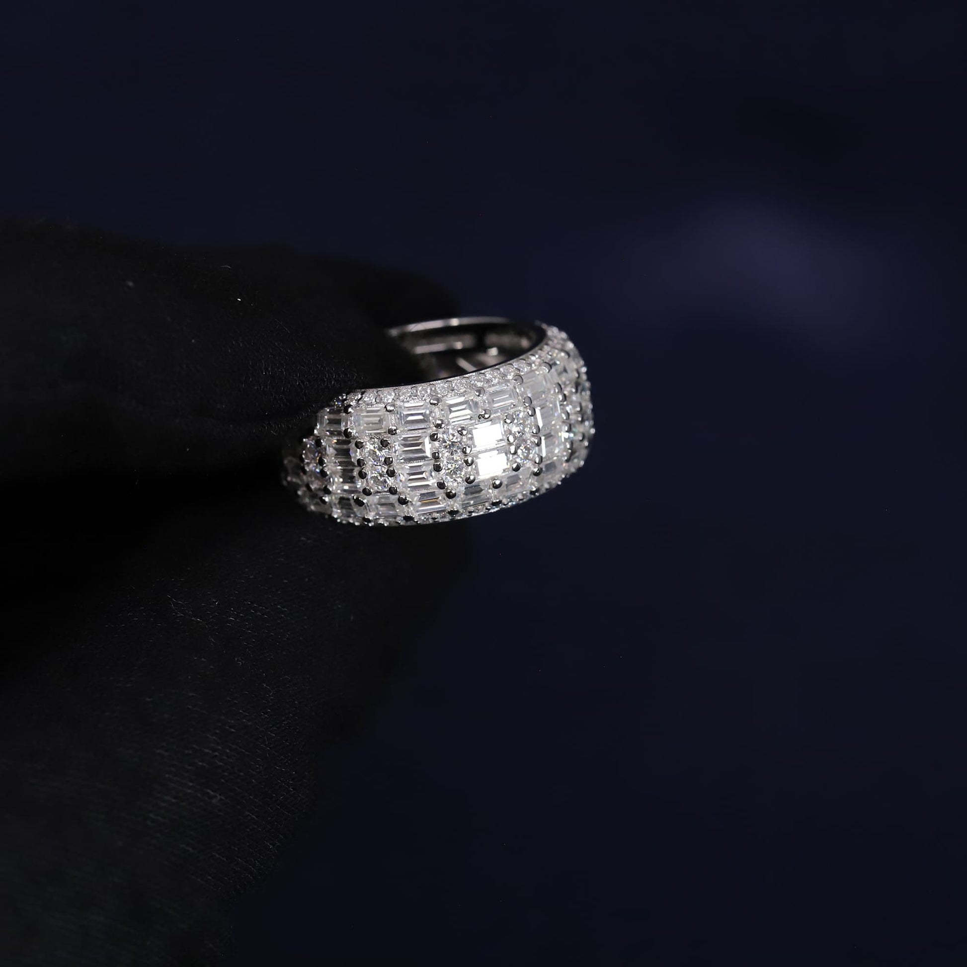 Silver ring with gemstones on a dark background