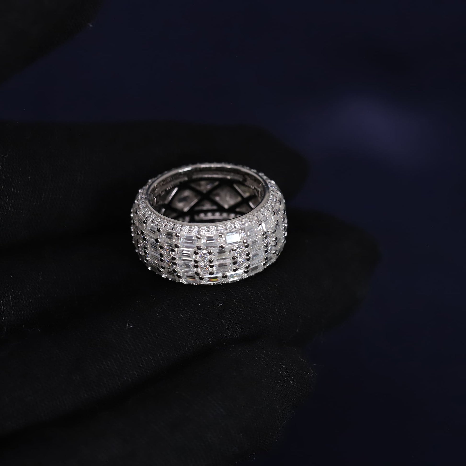 Silver ring with gemstones on a dark background