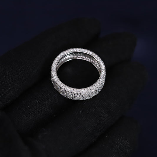 Silver ring with small stones on a black fabric background