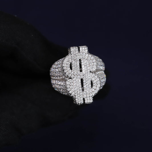 Silver dollar sign ring with clear stones on a black background