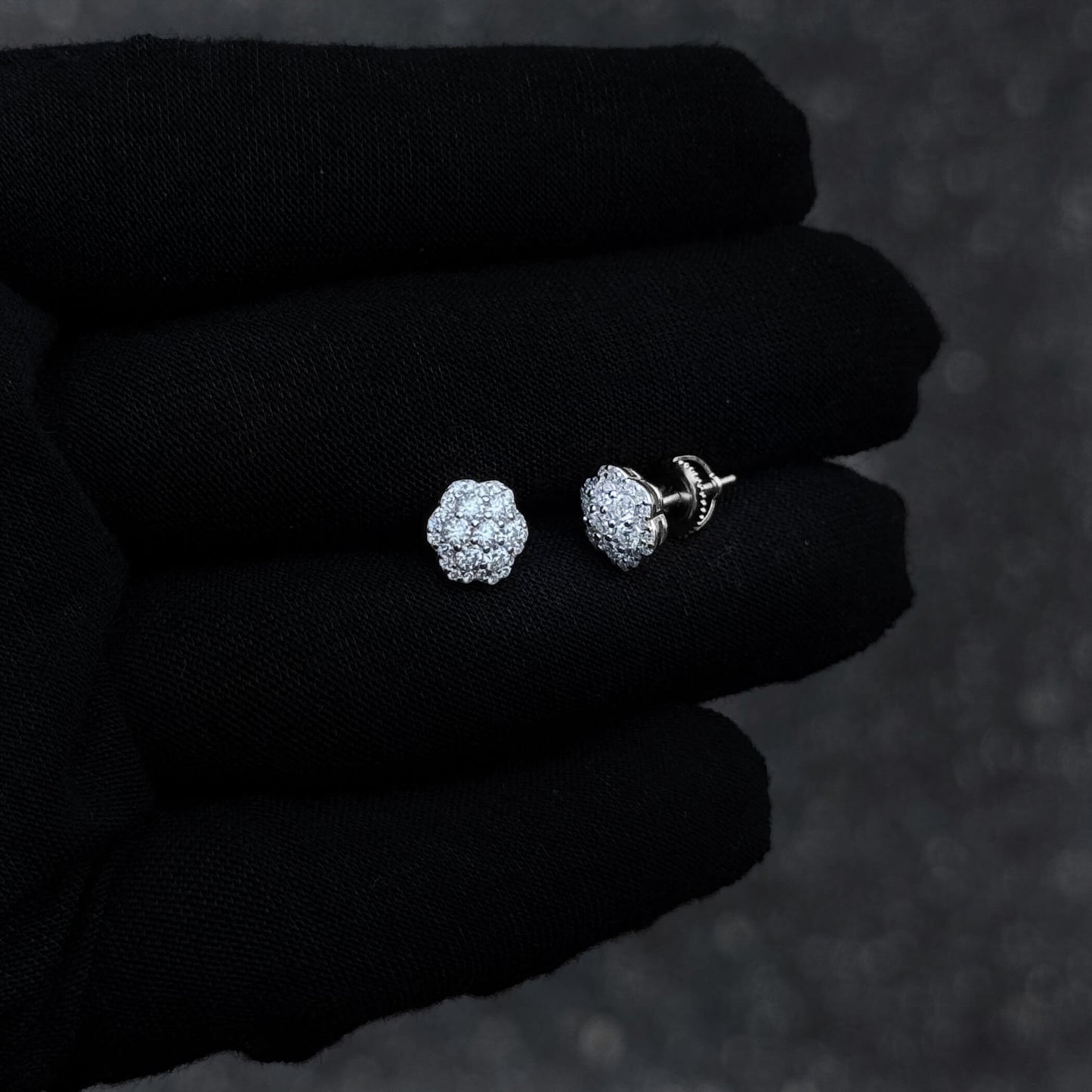 9mm moissanite flower cluster studs displayed on black gloves with screw-back posts.