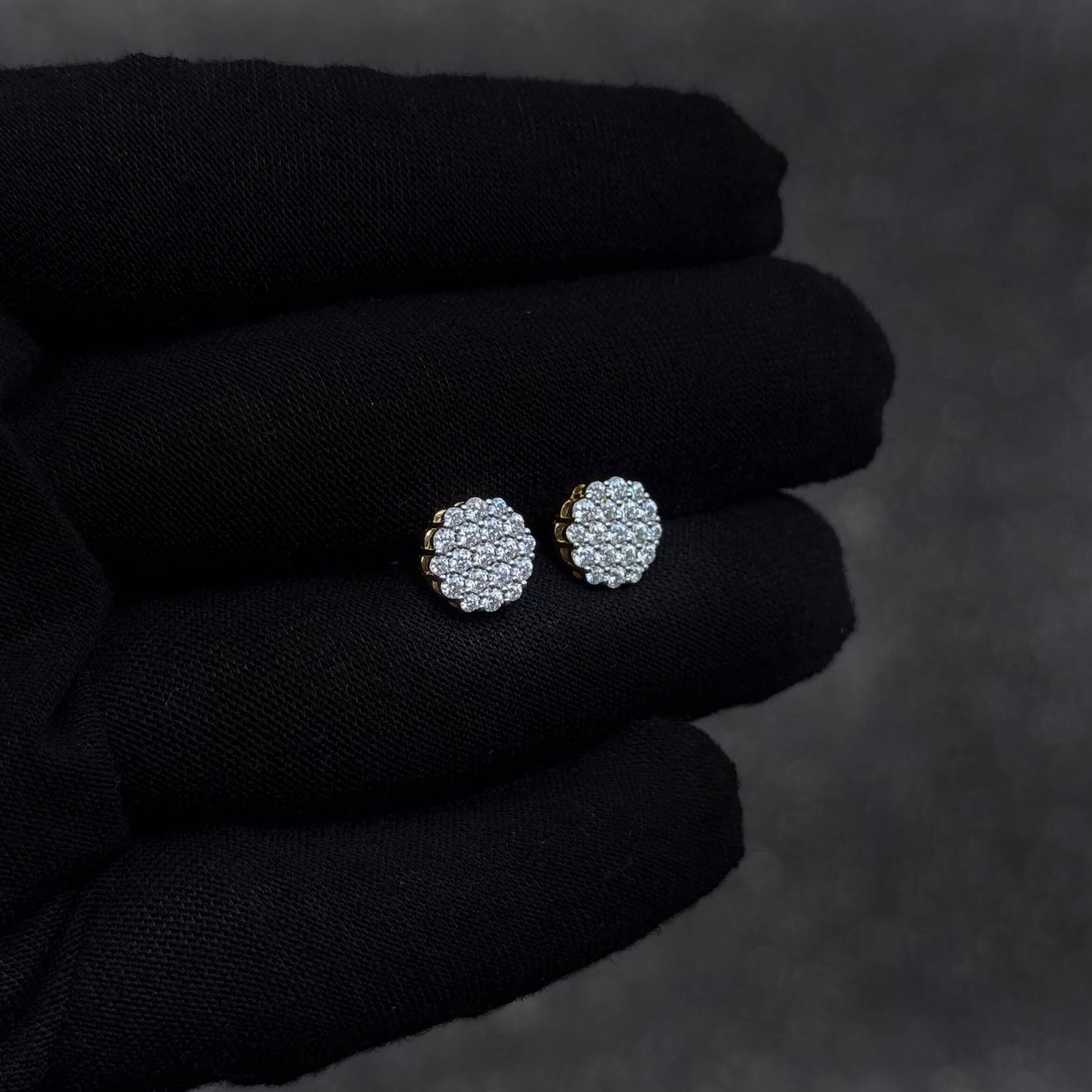 Side-angled view of 9mm Moissanite cluster diamond studs in sterling silver on glove.