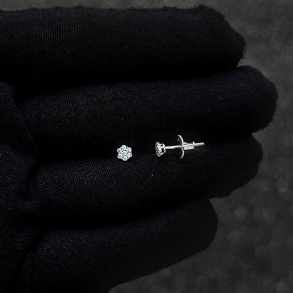 Sterling silver moissanite cluster earring and screw-back post shown on black glove.