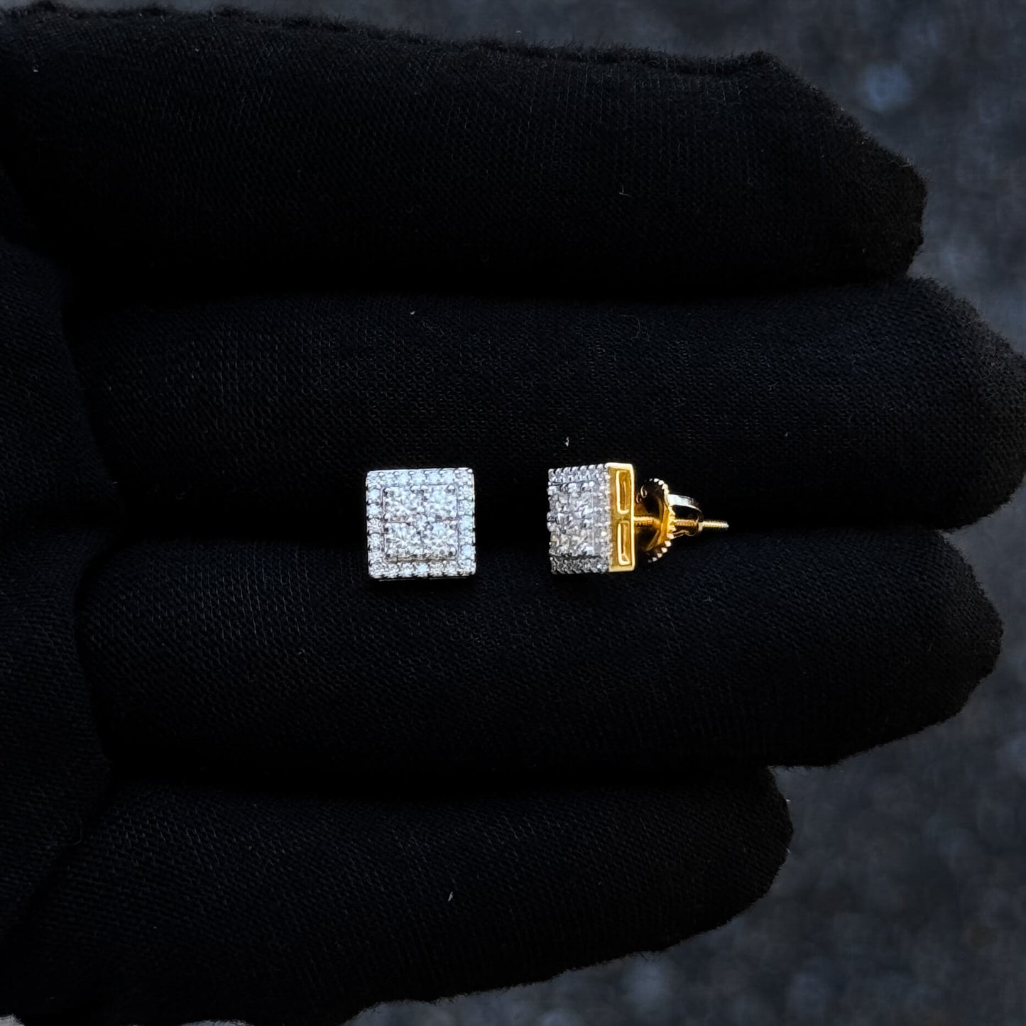 Sterling silver 8mm square moissanite cluster diamond stud earrings shown on black glove.