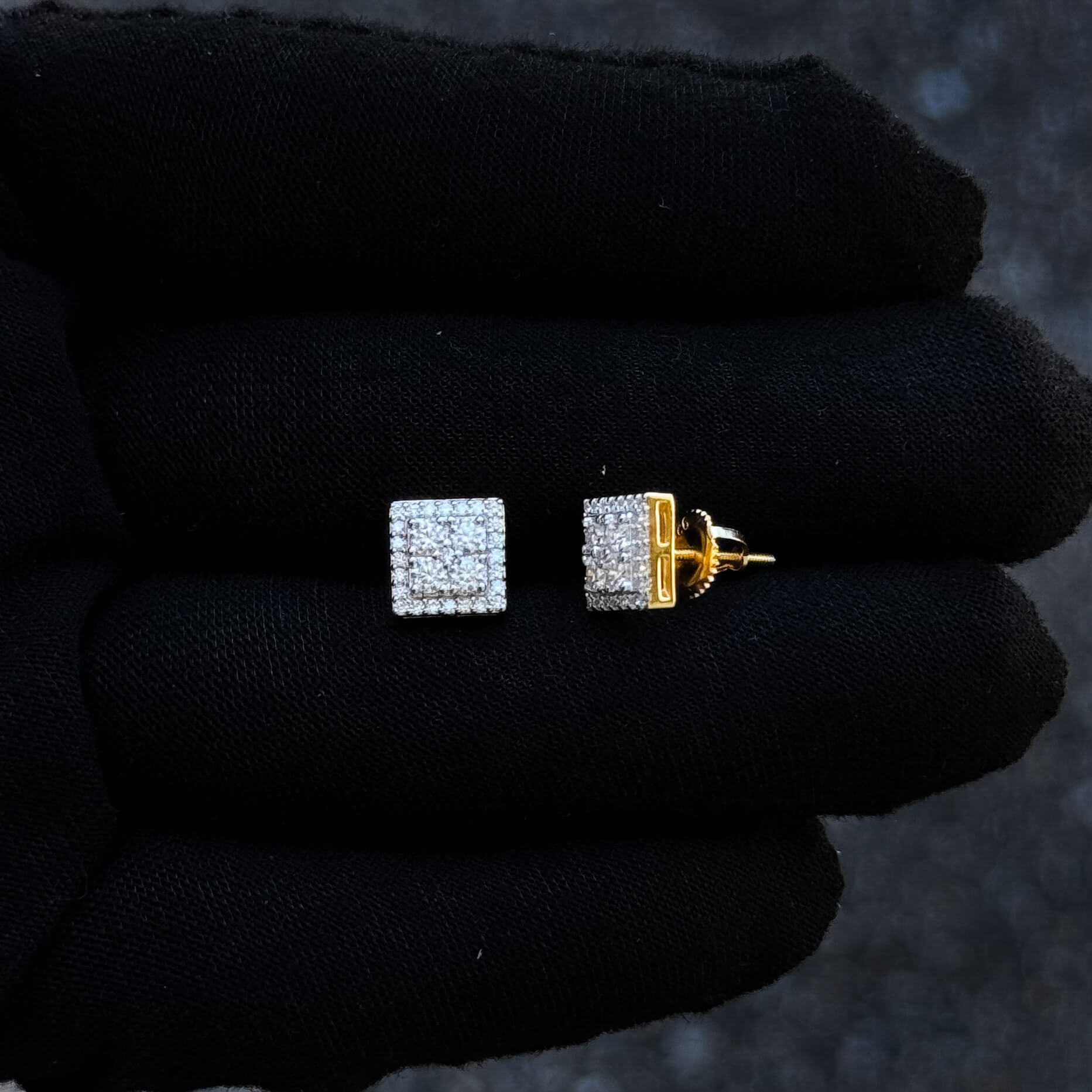 Sterling silver 8mm square moissanite cluster diamond stud earrings shown on black glove.
