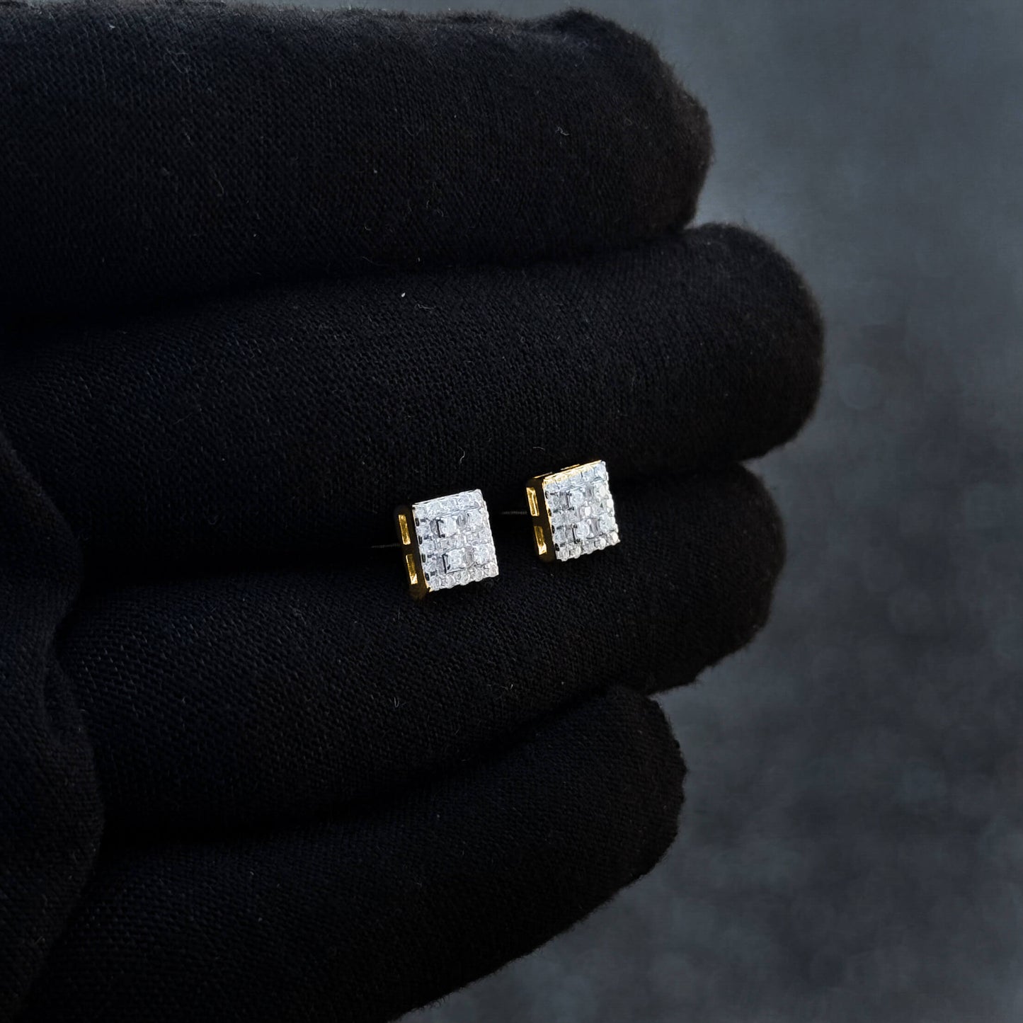 7mm moissanite cluster earrings with 0.37ct diamonds and gold backing displayed on black glove.