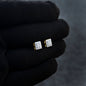 7mm moissanite cluster earrings with 0.37ct diamonds and gold backing displayed on black glove.