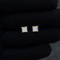 Gold-trim 6mm square moissanite cluster stud earrings displayed on black glove for detail view.