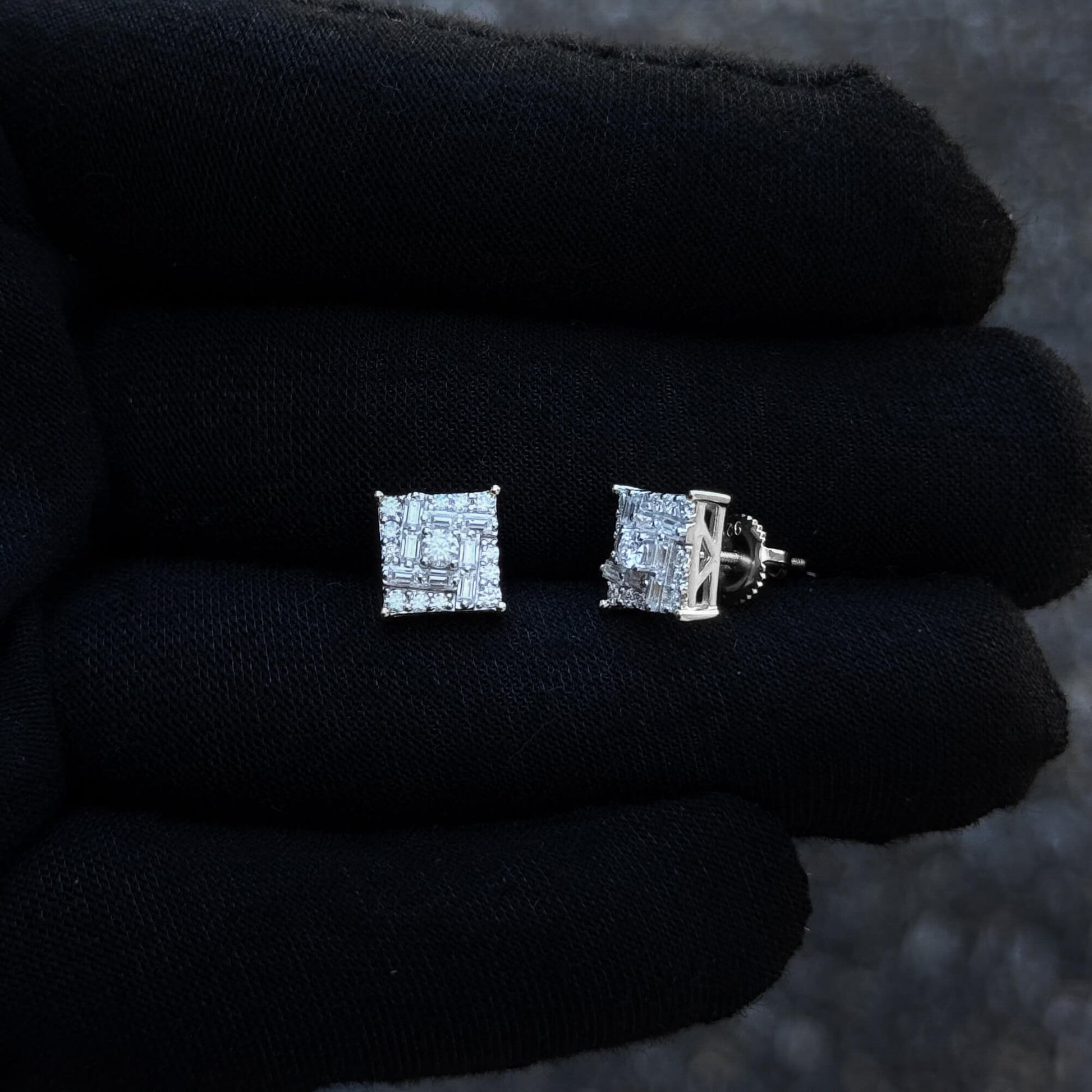 Front and side view of 9mm square moissanite cluster earrings with screw-back posts on glove.