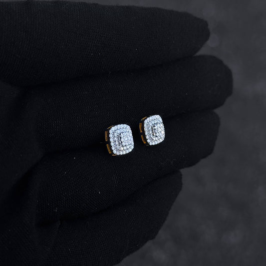 Gold-trim square moissanite cluster earrings shown on black glove, featuring triple halo diamond detail.