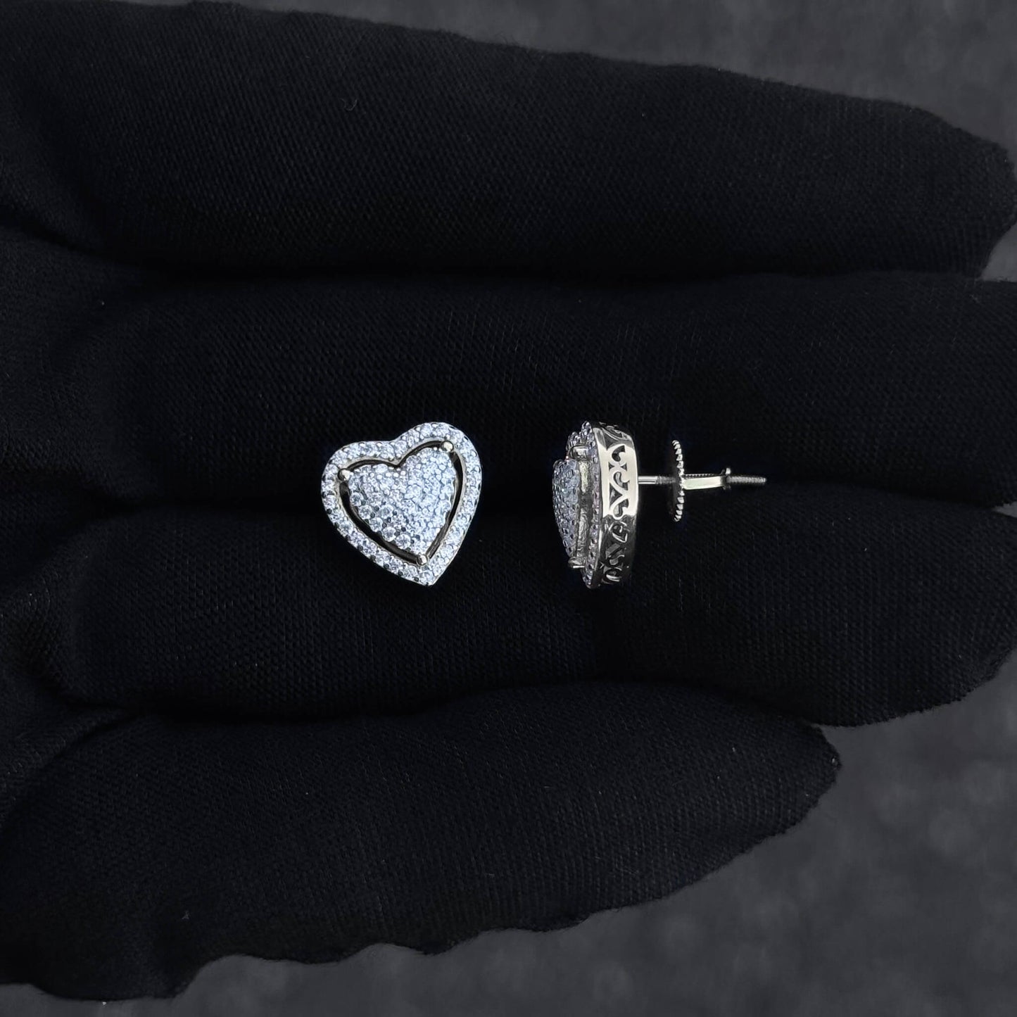 Close-up of heart moissanite cluster earring and screw-back post in sterling silver setting.