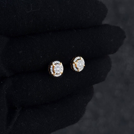 Gold halo moissanite cluster stud earrings shown on black glove with round diamond pavé accents.