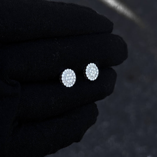 Small round 8mm moissanite and diamond cluster stud earrings displayed on black glove.