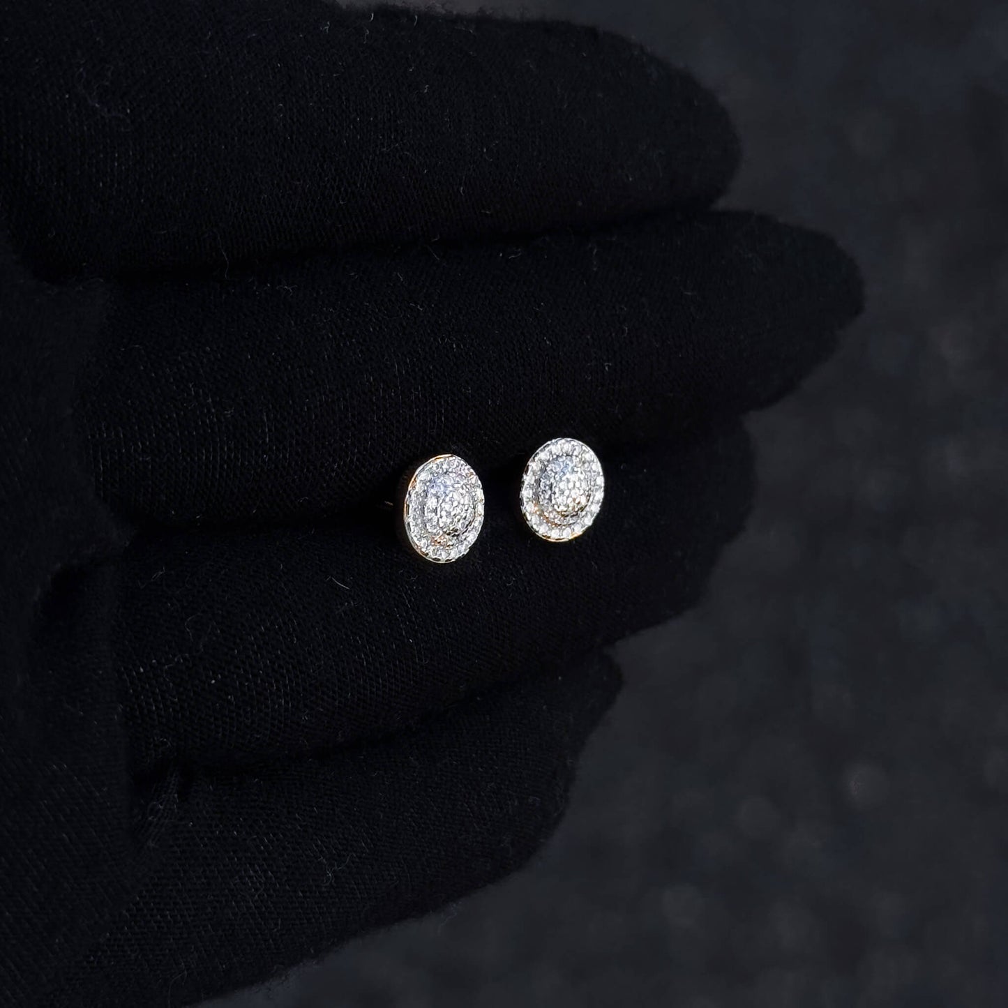 Small 8mm Moissanite cluster diamond studs shown on black glove with gold-tone backing.