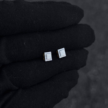 Small 6mm sterling silver square moissanite cluster studs shown on black glove for size comparison.