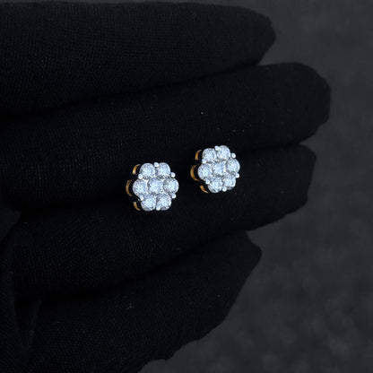 Small 10mm sterling silver moissanite cluster stud earrings with bright round diamonds on hand.