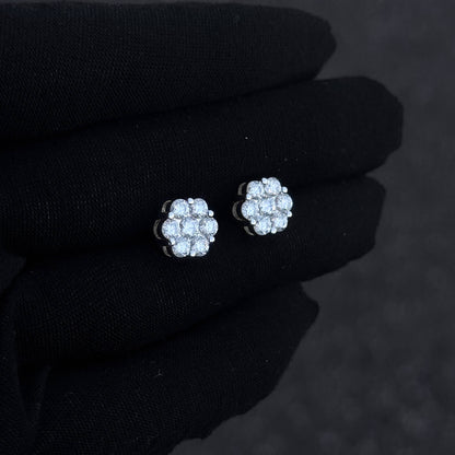 Sterling silver 10mm moissanite cluster diamond studs shown on black glove in angled view.