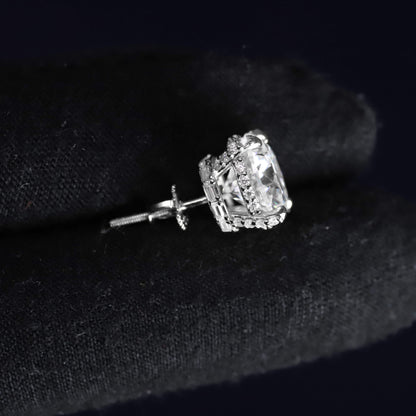 Silver earring with a clear gemstone on a black background