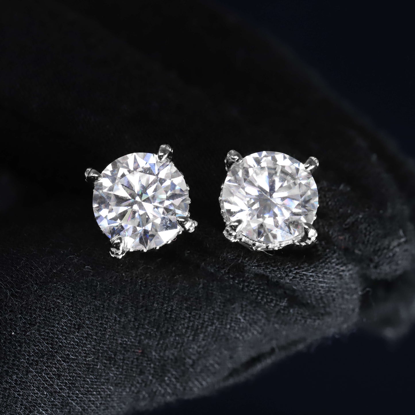 Pair of diamond stud earrings on a black background