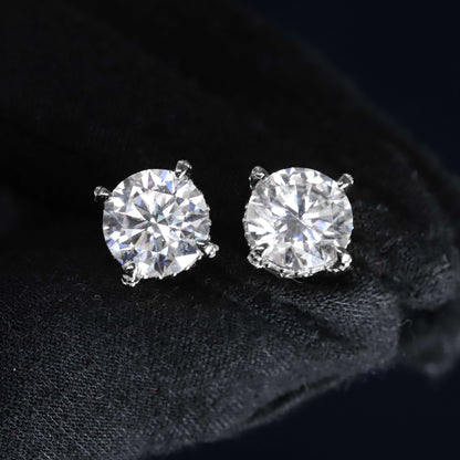 Pair of diamond stud earrings on a black background