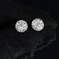 Pair of diamond stud earrings on a black background