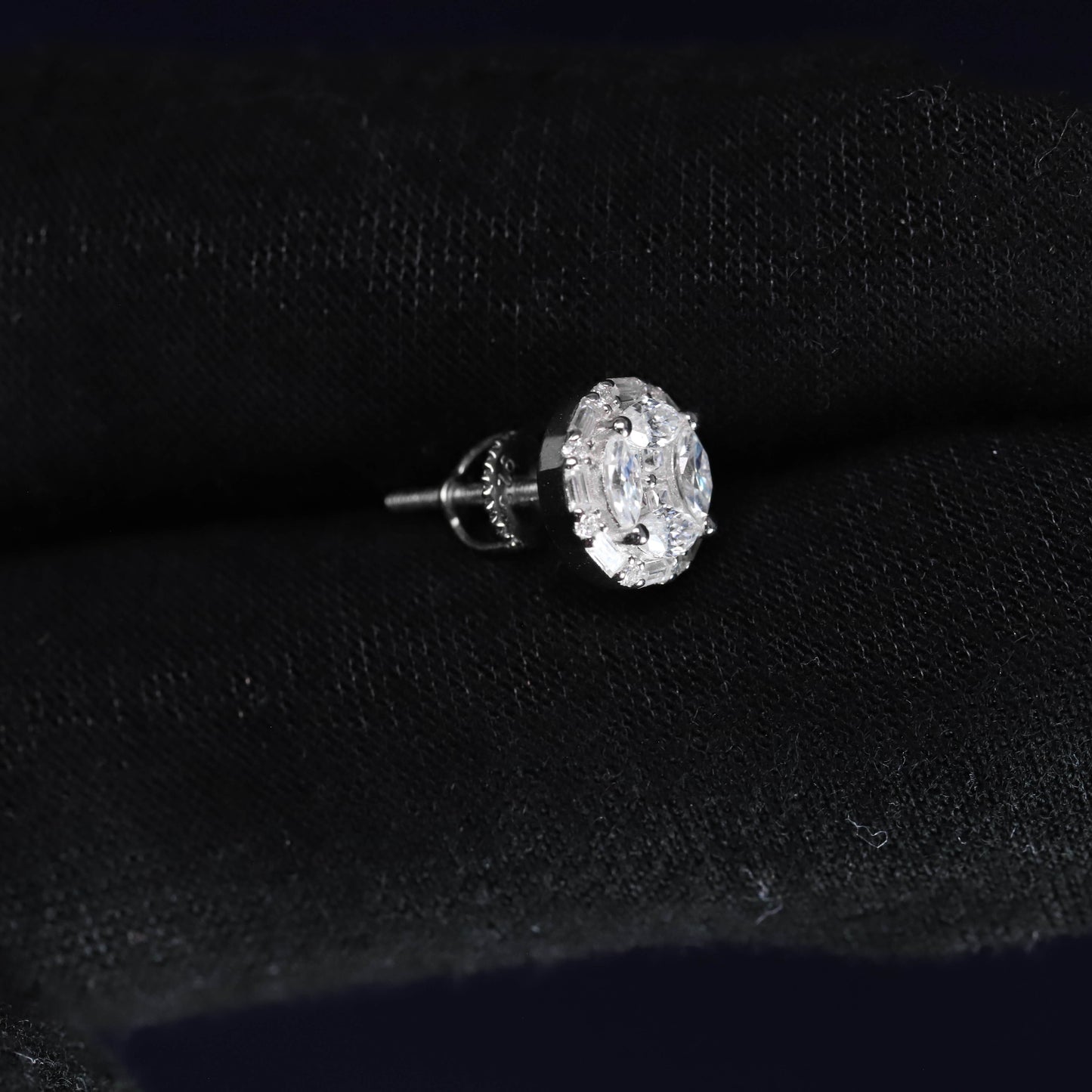 Diamond earring on a black velvet background