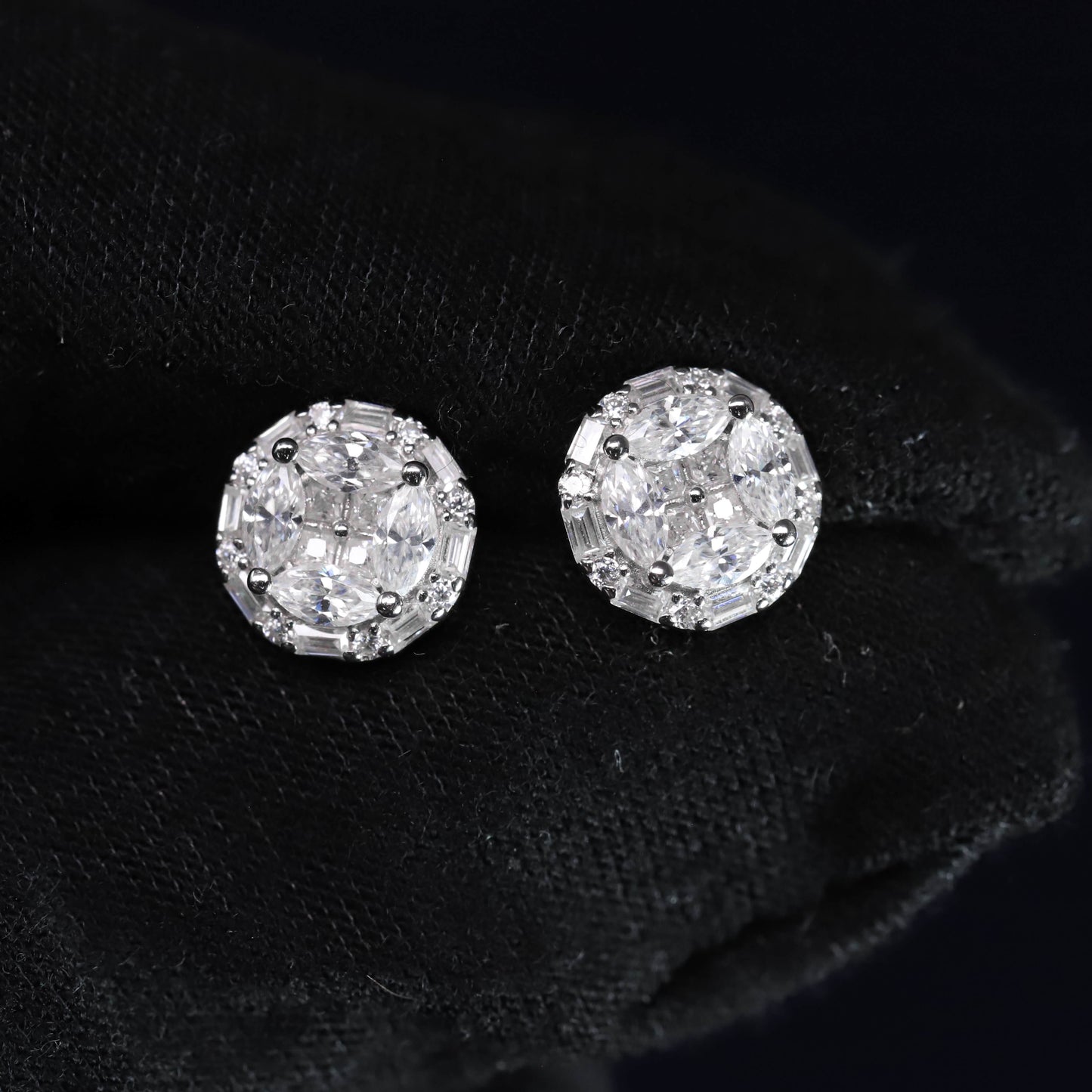 Pair of diamond stud earrings on a black background