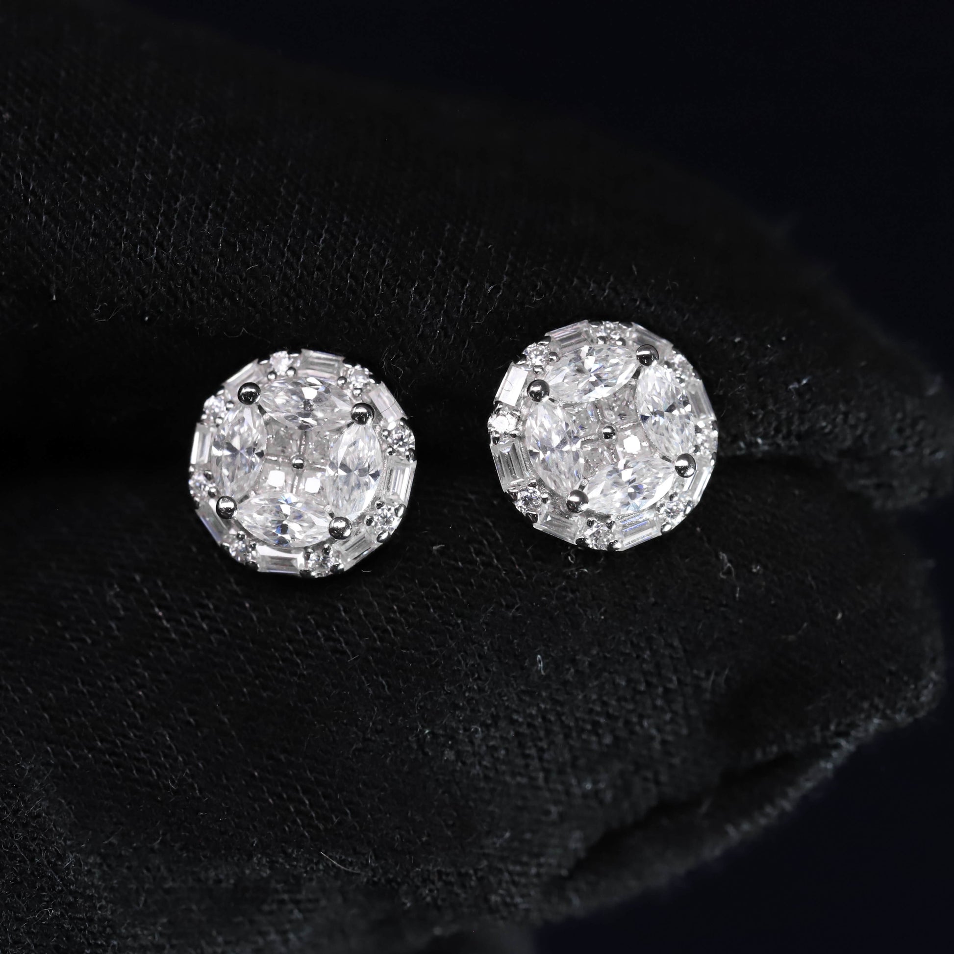Pair of diamond stud earrings on a black background