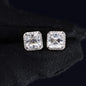 Square-cut diamond earrings on a black background