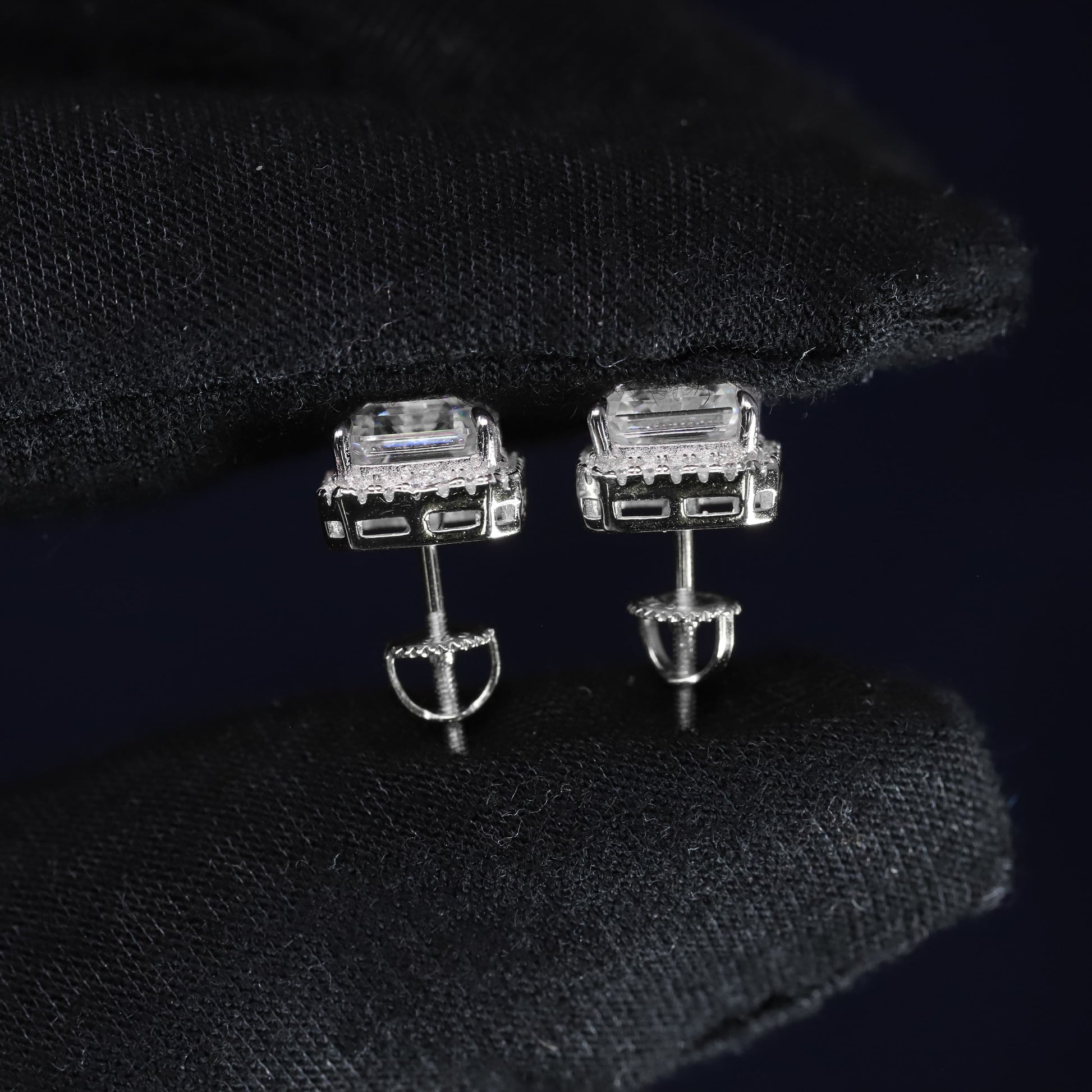 Silver earrings with gemstones on a black background