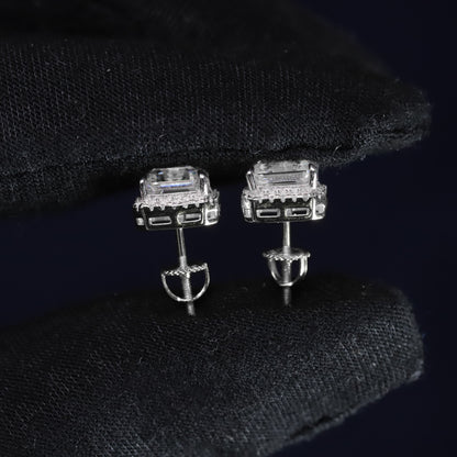 Silver earrings with gemstones on a black background