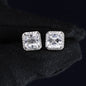 Pair of square-cut diamond earrings on a black background
