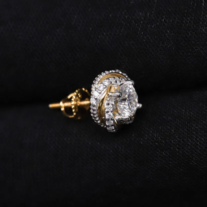 Gold and diamond earring on a black background