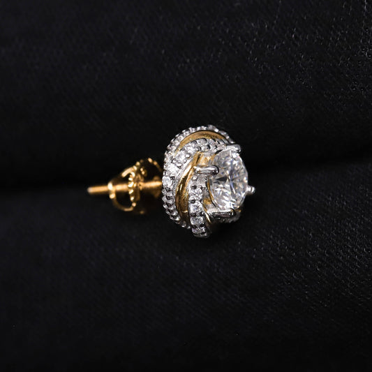 Gold and diamond earring on a black background