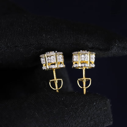 Gold earrings with clear gemstones on a black background