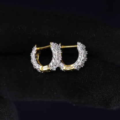 Gold hoop earrings with diamond accents on a black background