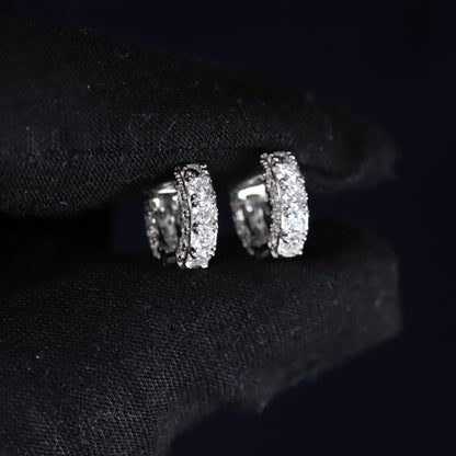 Silver earrings with gemstones on a black background