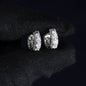 Silver earrings with gemstones on a black background