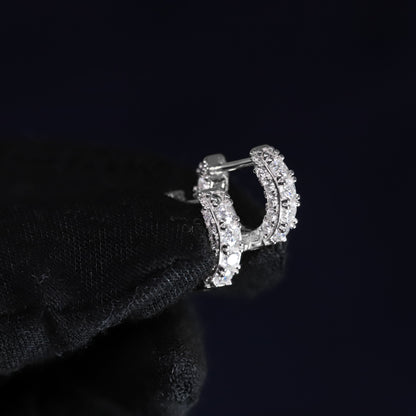 Silver letter 'D' earring on a black background