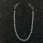 Beaded necklace on a textured black surface