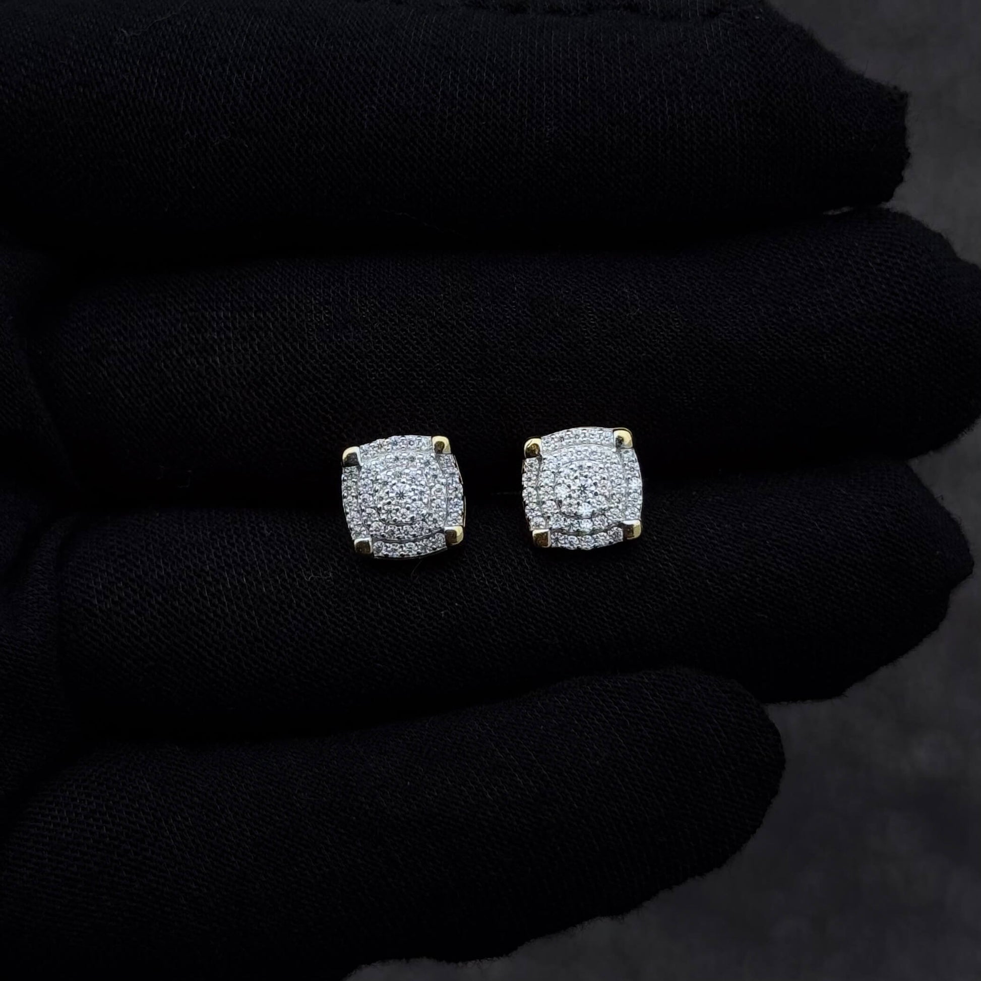 9mm moissanite cluster diamond stud earrings with gold accents displayed on a black glove.