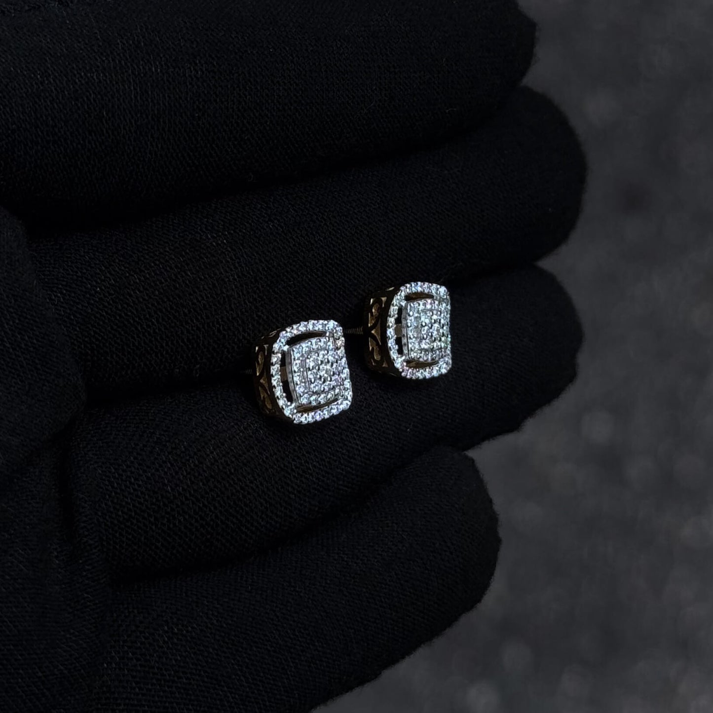 Side-angle view of square 10mm Moissanite cluster diamond stud earrings with gold-accented setting.