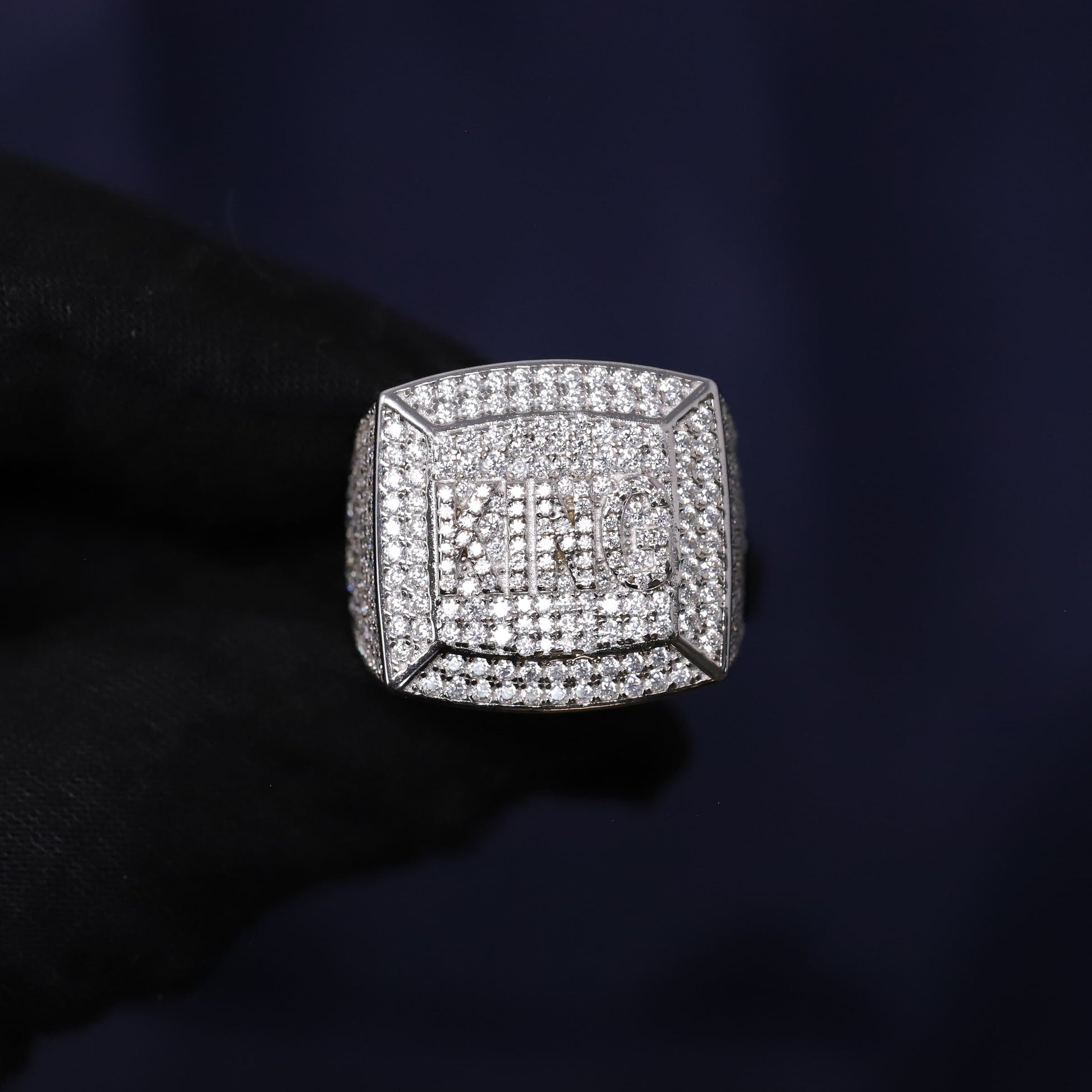 Silver ring with diamonds on a dark background