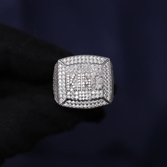 Silver ring with diamonds on a dark background
