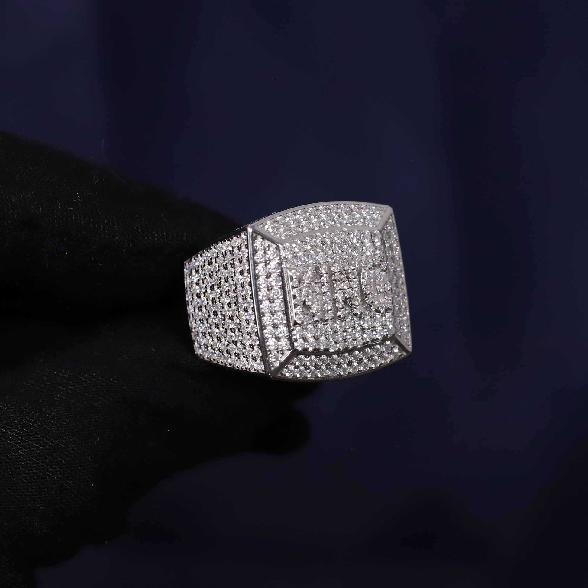 Silver ring with gemstones on a dark background