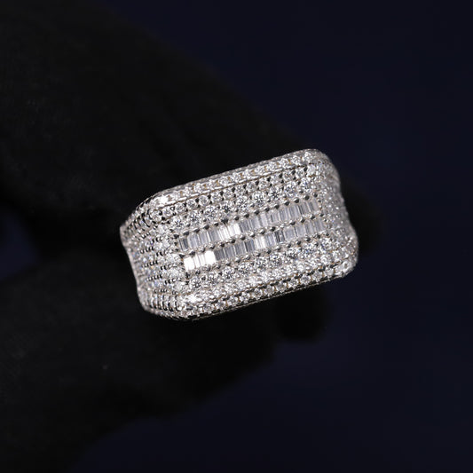 Silver ring with multiple rows of diamonds on a dark background